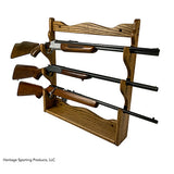 Wall mounted gun rack holding three hunting rifles horizontally  made from American hardwood. Brand: Heritage Sporting Products
